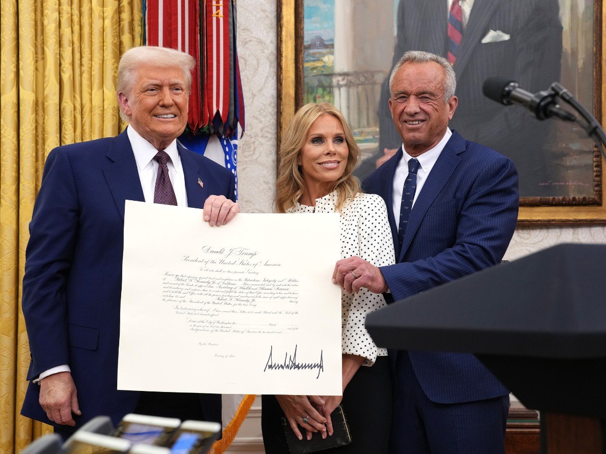 WASHINGTON, DC - FEBRUARY 13: U.S. President Donald Trump, Robert F. Kennedy Jr., and Kennedy's wife Cheryl Hines pose after Kennedy was sworn in as Secretary of Health and Human Services in the Oval Office at the White House on February 13, 2025 in Washington, DC. Kennedy, who faced criticism for his past comments on vaccine, was confirmed by the Senate 52 to 48. Former Senate Republican Leader Mitch McConnell (R-KY) was the only Republican to vote against him. (Photo by Andrew Harnik/Getty Images)