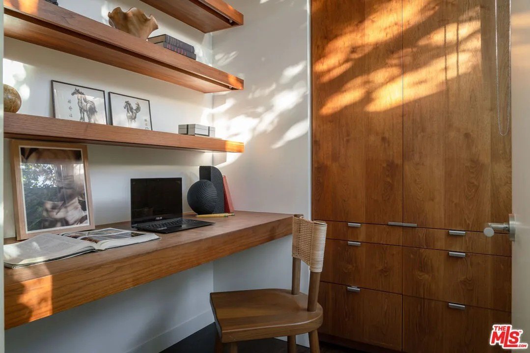 Wallnut paneling, bookshelves and cabinetry can be found in almost every room.