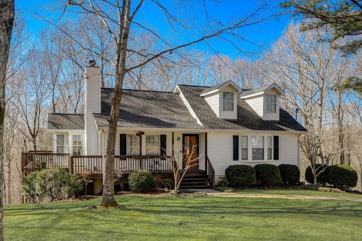 farmhouse with wrap-around porch and dormer windows