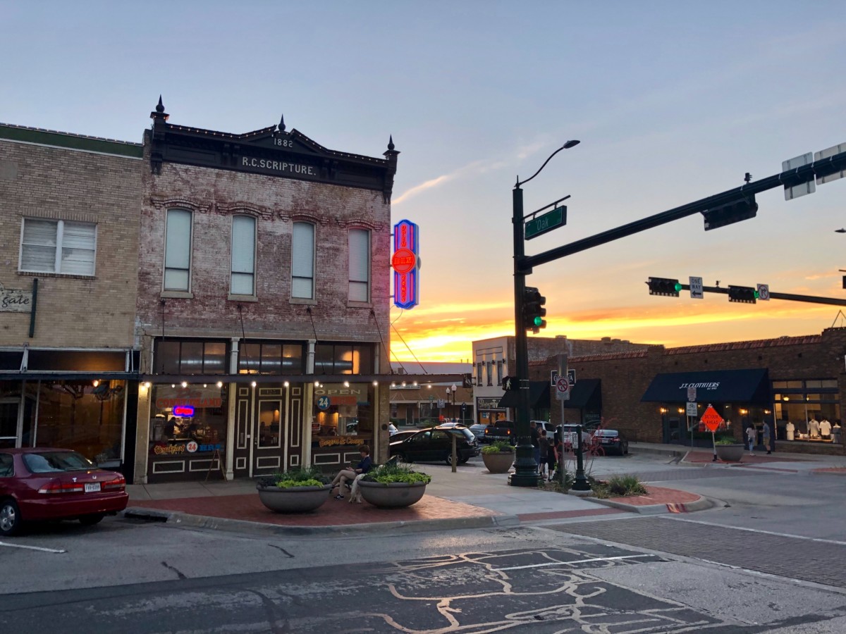 main street in a city with an old building and stoplight