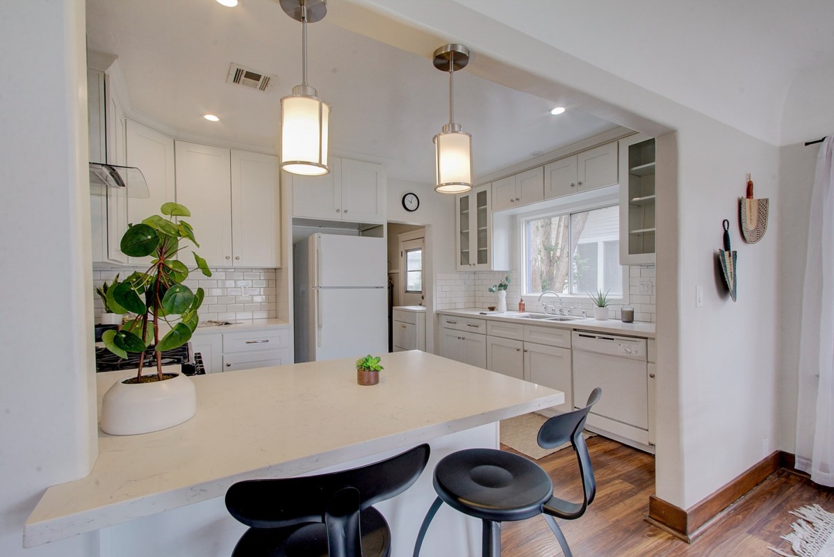 g-shaped kitchen with lots of upper cabinets and a narrow space for entering