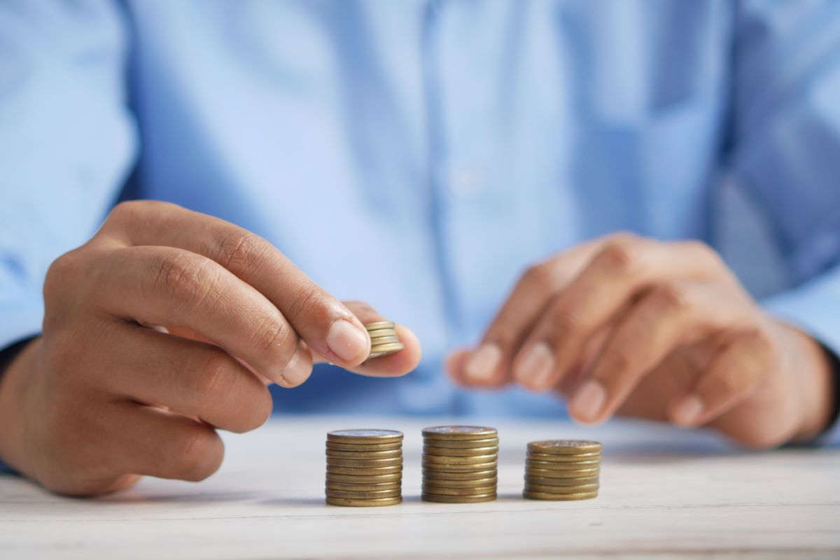 person counting coins on a table