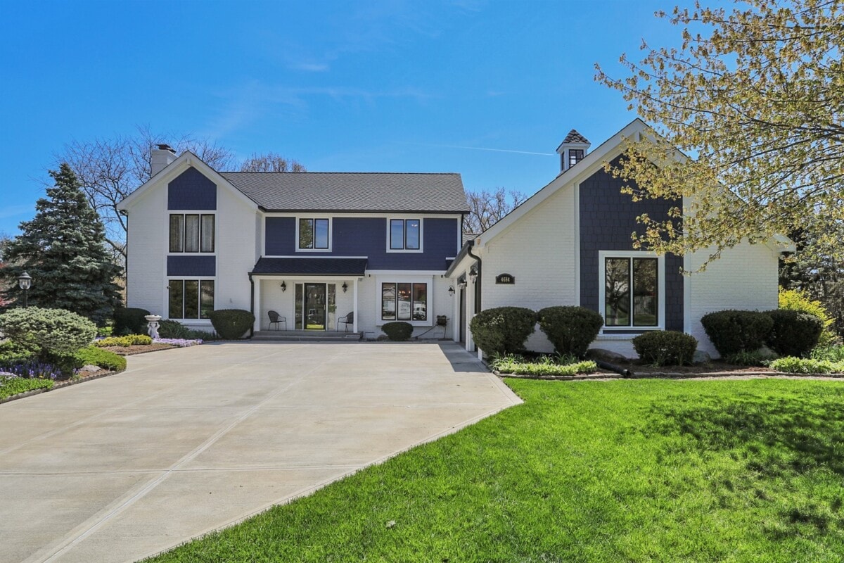 blue and white home with manicured grass for rent