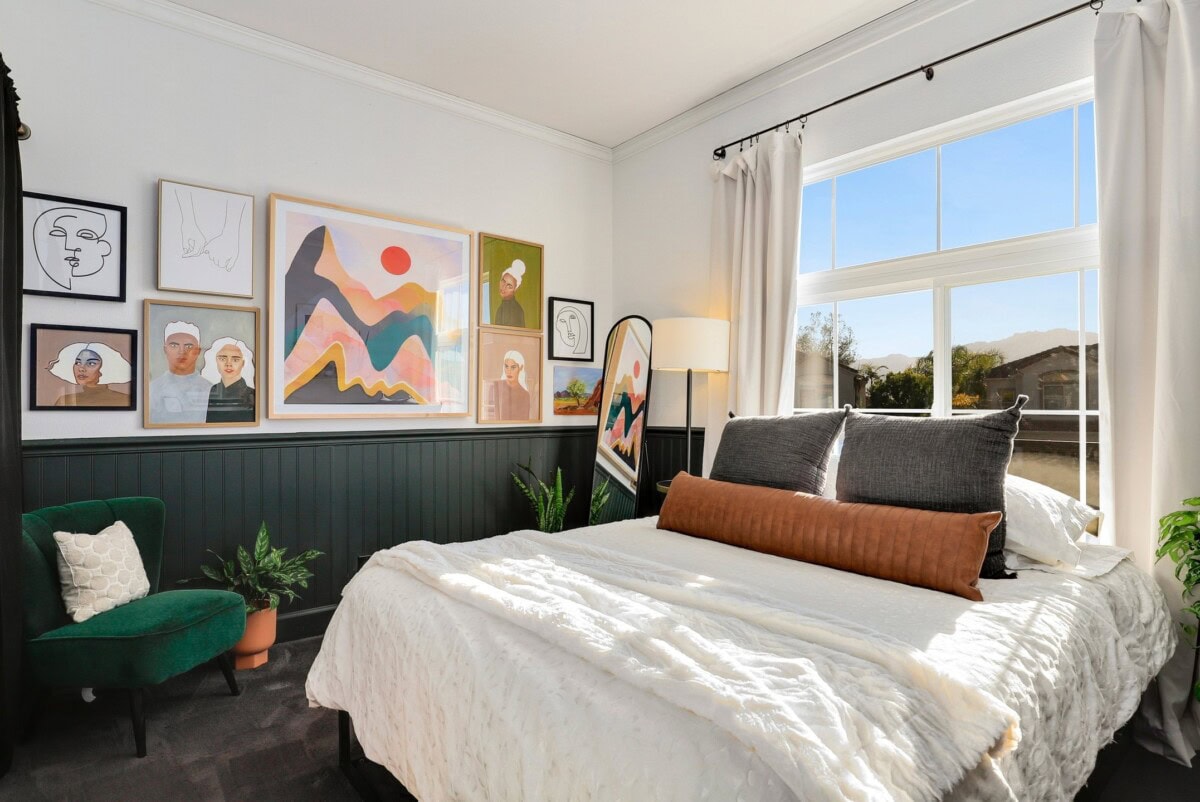 A bedroom with paintings