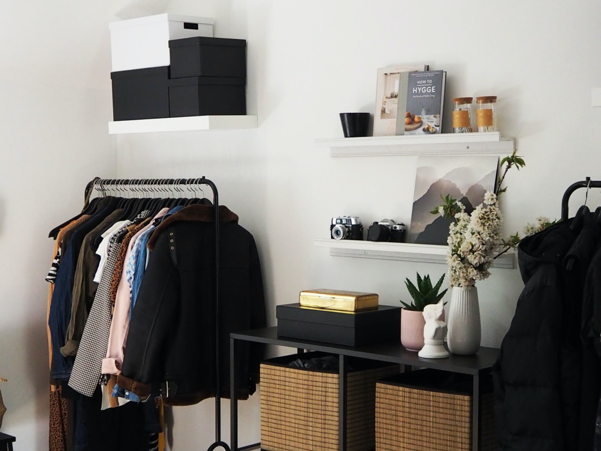 room with a standing shelf for clothing