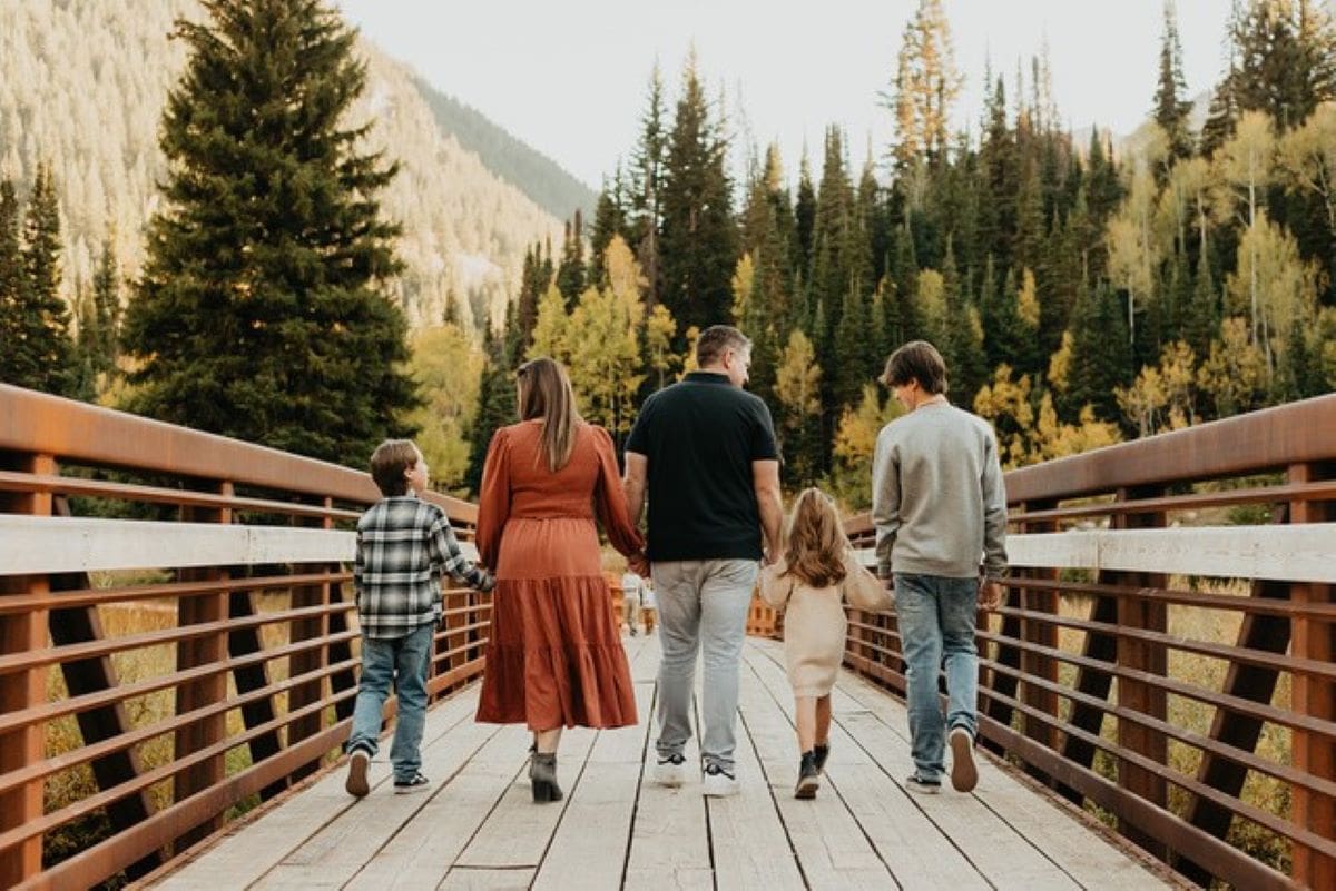 family crossing bridge at jordan pines campground