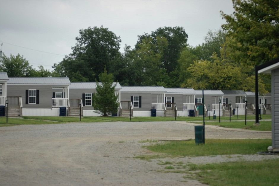 An example of what a community might look like if you are buying a mobile home. Rows of similar houses sit on a path. 