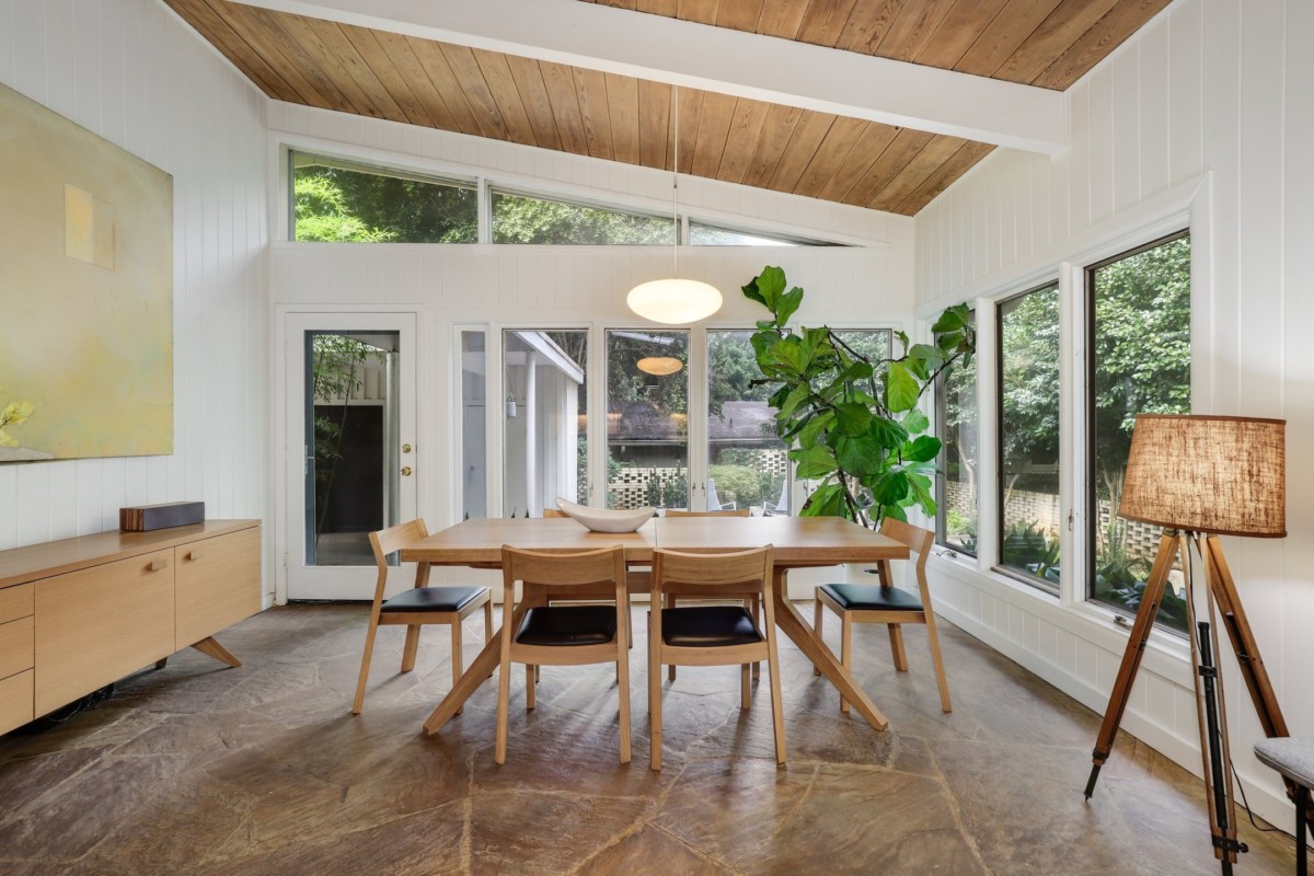 minimalist dining room with white walls and wood accents