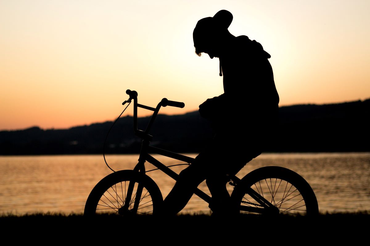 person on a bike next to a lake