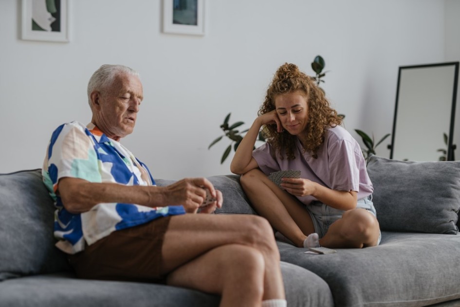 Grandfather and granddaughter playing cards