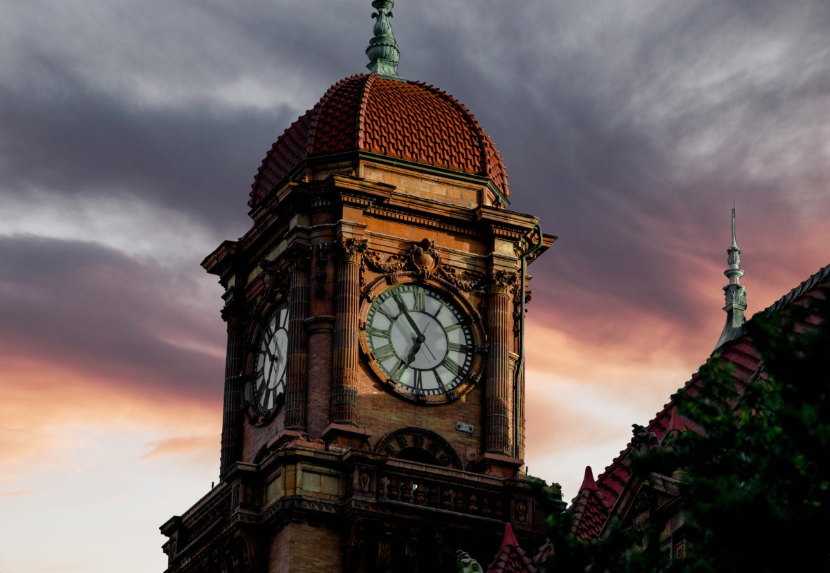 view of a clocktower in richmond with dark clouds behind it