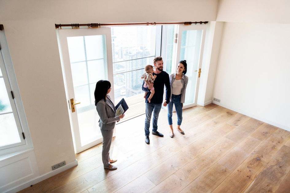 A family with a real estate agent during a house tour.