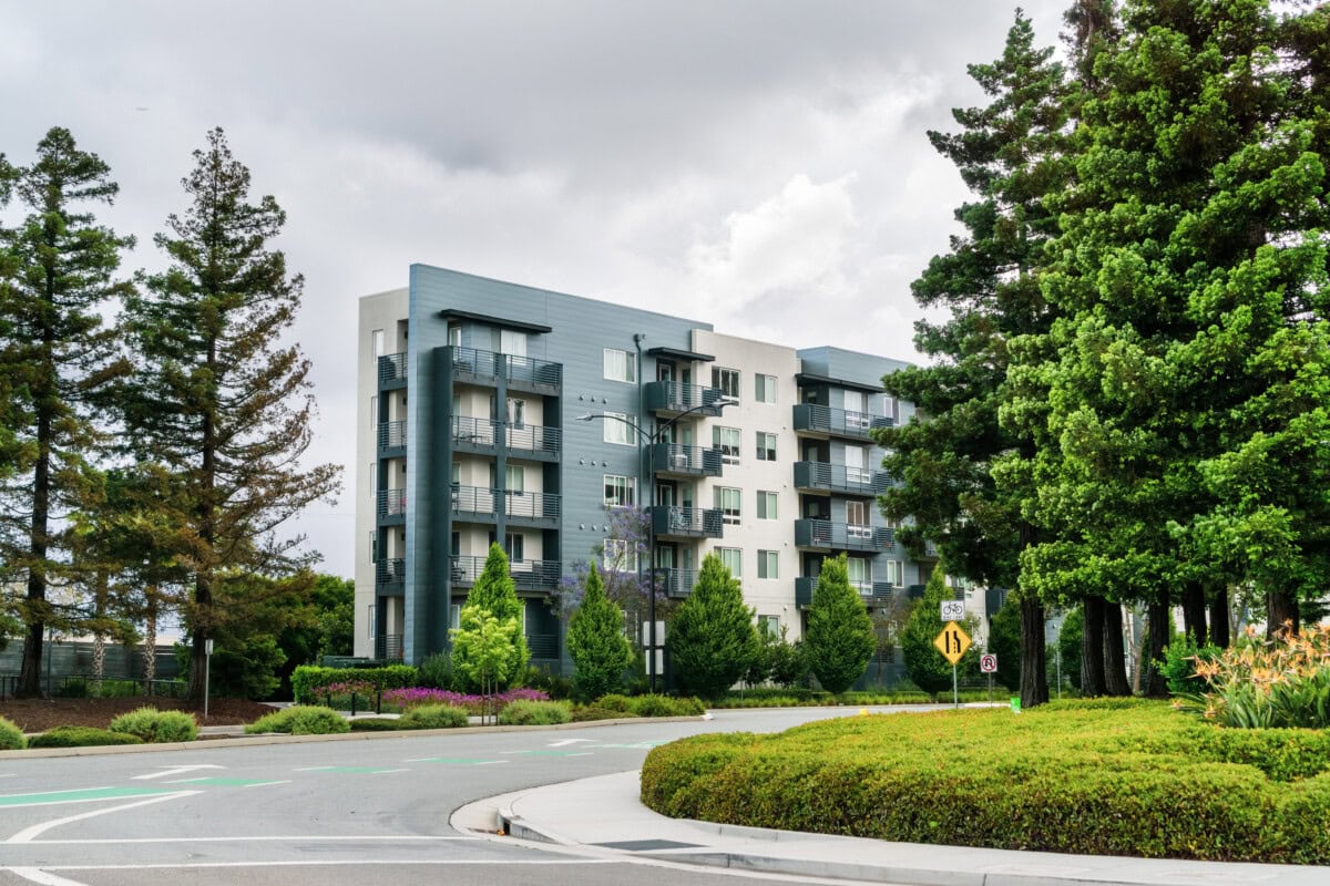 apartment complex with trees and road