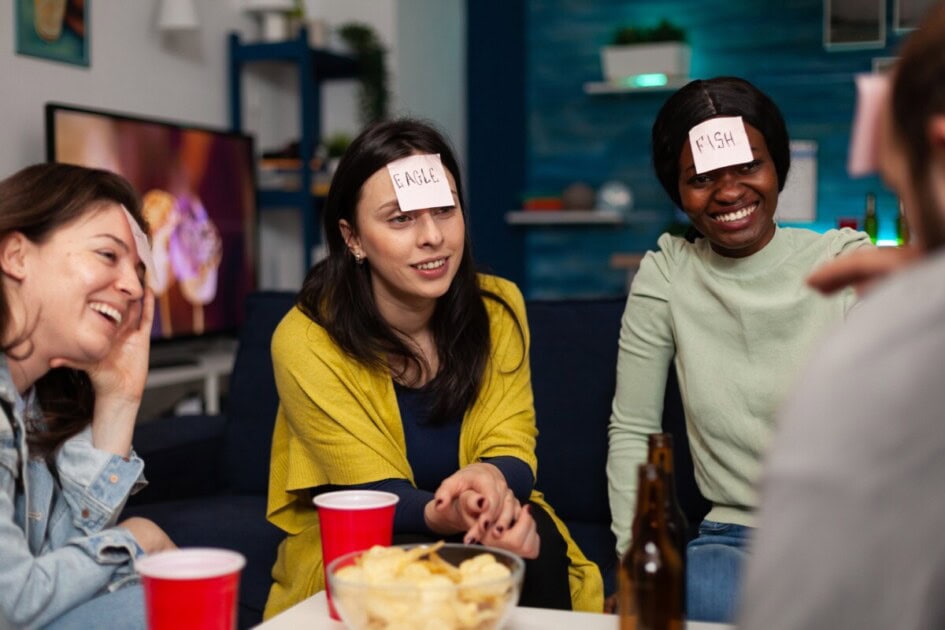 Four friends play game with words on their foreheads to guess each others' words