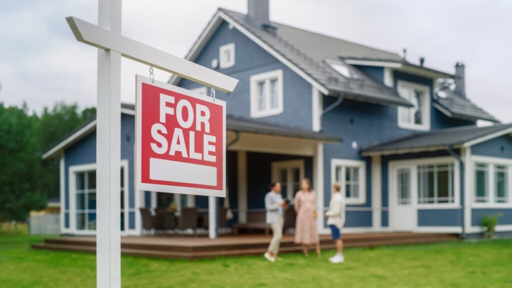 A for sale sign in front of a house.