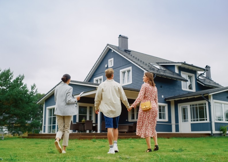 real estate agent showing a couple a house