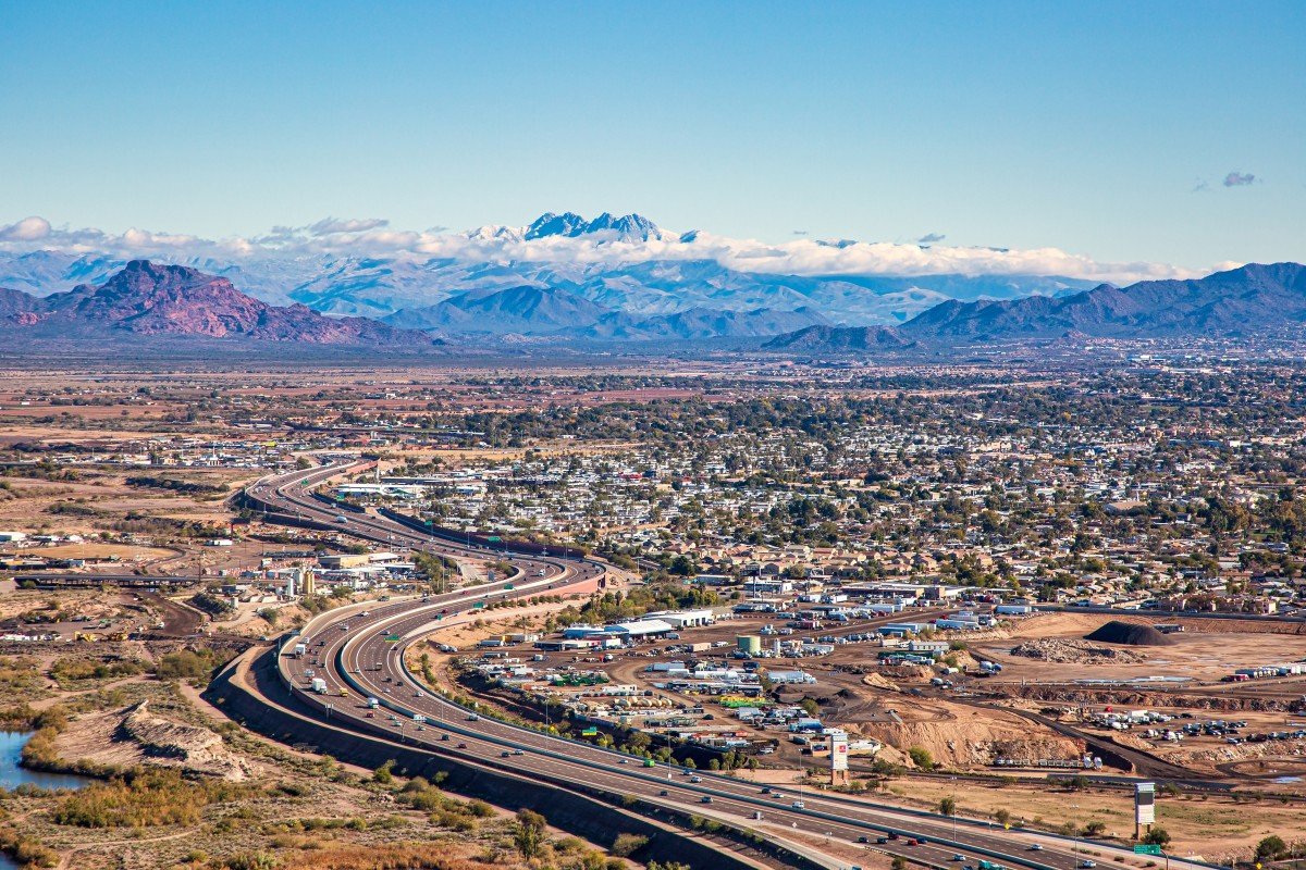 Aerial view of East Mesa, Arizona with Red Mountain, the Superstition Mountains and Four Peaks shrouded in clouds