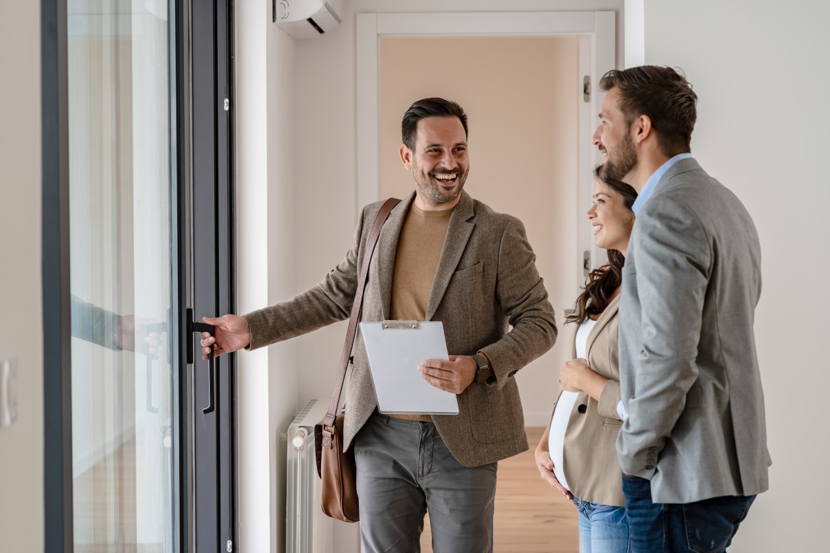 real estate agent touring couple