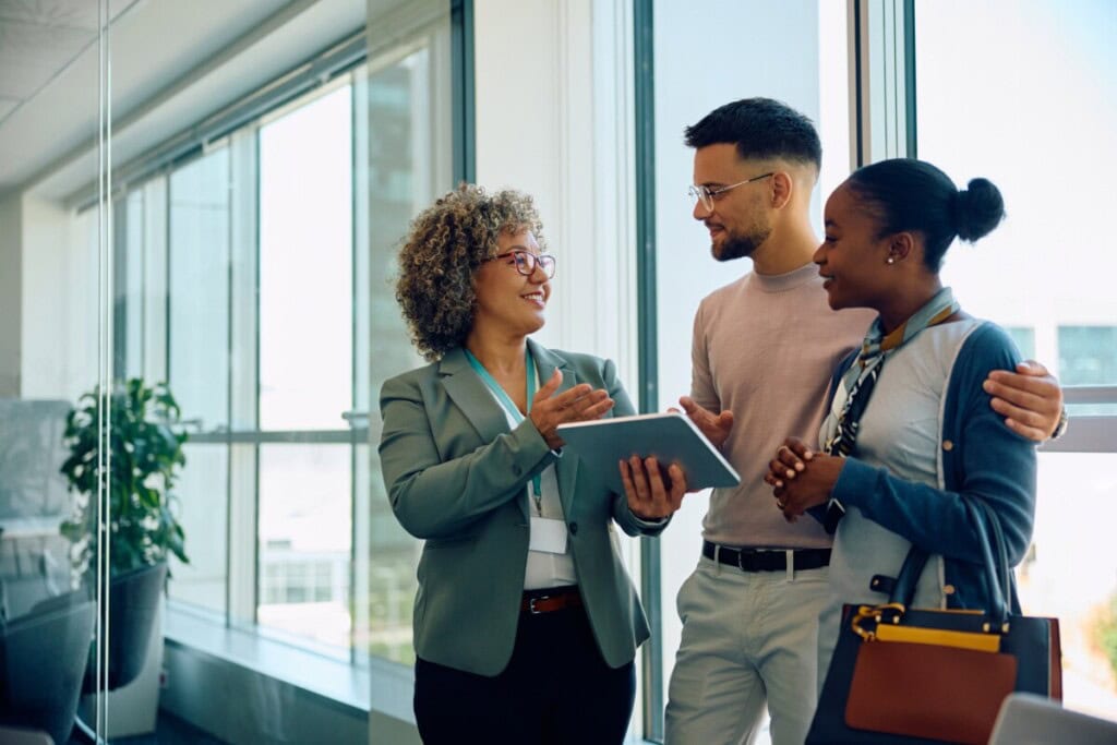 A couple talks to a real estate agent about how much house they can afford on $100k salary.