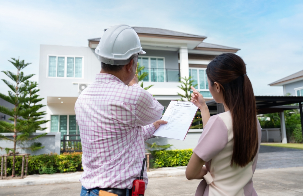 home inspector and potential buyer examining the home