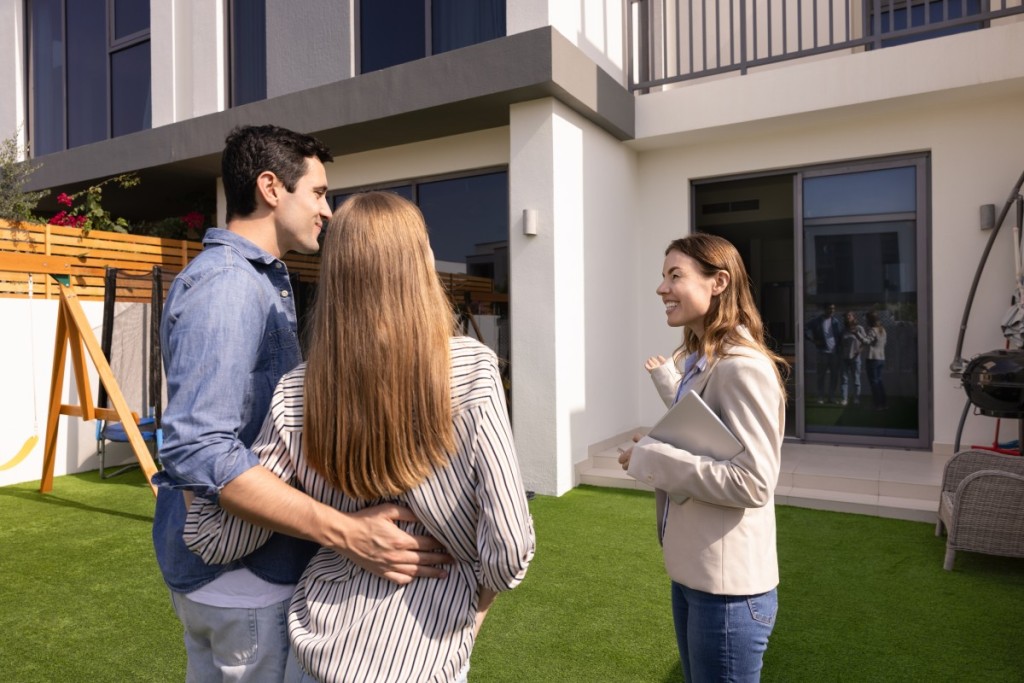 A real estate agent shows a family how much house they can afford on a $200k salary.