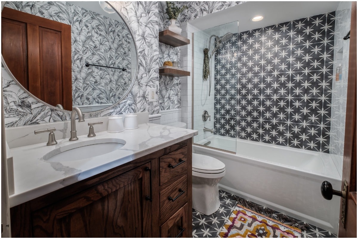 A bathroom with black shower tile